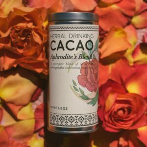 A jar of Herbal Drinking Cacao on a bed of roses. drinking cacao