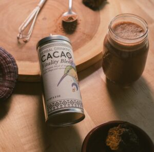 A mug of Herbal Drinking Cacao with steam rising from the surface.